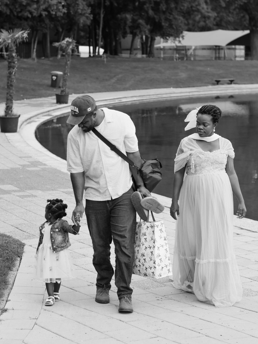 Dad, Mum and big sister walking together by the water