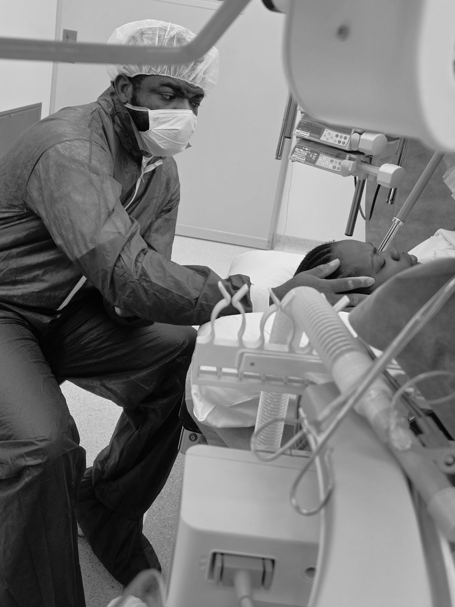 Dad in scrubs comforting Mum in the delivery room